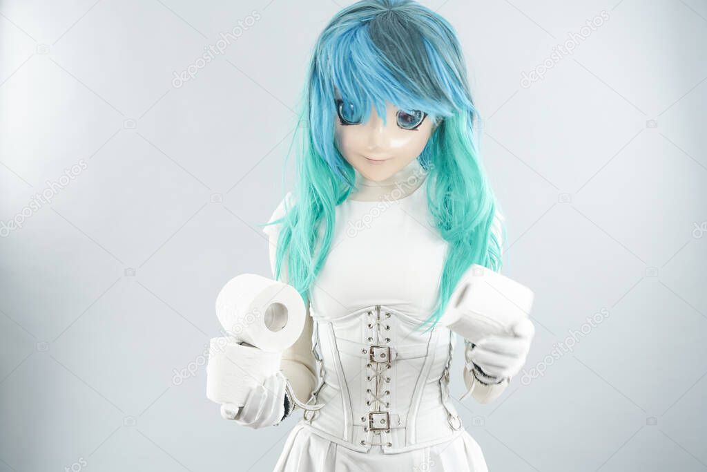 A woman is wearing a face mask for protection from the Corona Virus and has stocked up on her toilet paper stash in case of quarantine. Cosplayer in medical mask on white studio background