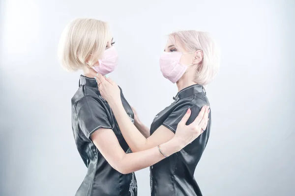 Dwie Europejskie Kobiety Ubrane Czarne Chińskie Sukienki Maski Medyczne Blondynki — Zdjęcie stockowe