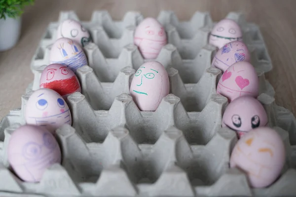 Do It Yourself easter eggs wearing mask for Easter holidays decoration. Selective focus with copy space. COVID-19 protection. Easter eggs with Corona virus COVID19 protection concepts.