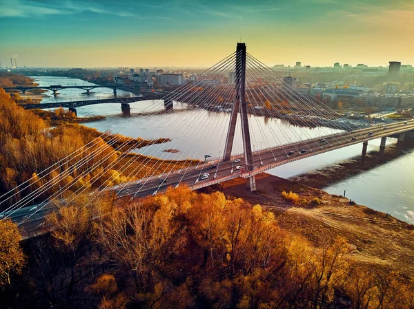 Beautiful panoramic aerial drone sunset view to Warsaw city center with skyscrapers and Swietokrzyski Bridge (En: Holy Cross Bridge) - is a cable-stayed bridge over the Vistula river in Warsaw, Poland — Stock Photo, Image