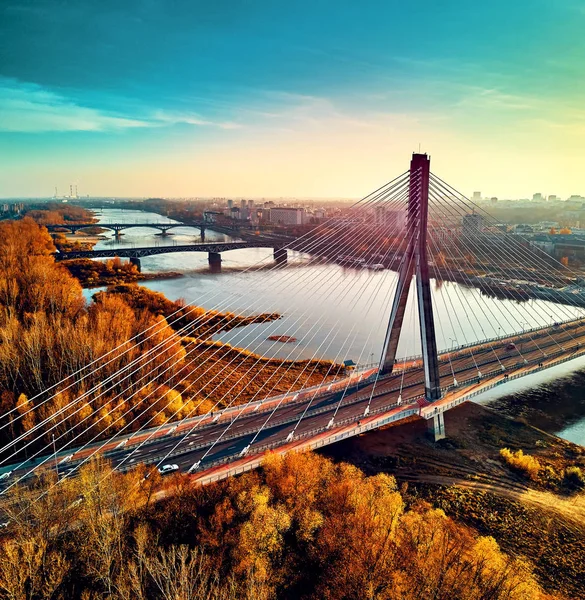 Beautiful panoramic aerial drone sunset view to Warsaw city center with skyscrapers and Swietokrzyski Bridge (En: Holy Cross Bridge) - is a cable-stayed bridge over the Vistula river in Warsaw, Poland — Stock Photo, Image