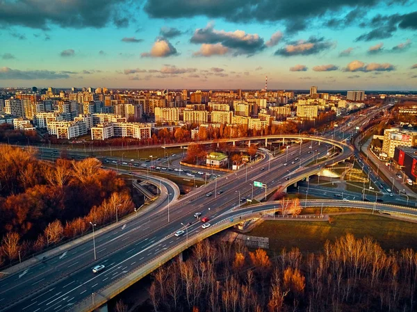 Beautiful panoramic aerial drone view to cable-stayed Siekierkowski Bridge over the Vistula river and Warsaw City skyscrapers, Poland in gold red autumn colors in November evening at sunset — Stock Photo, Image