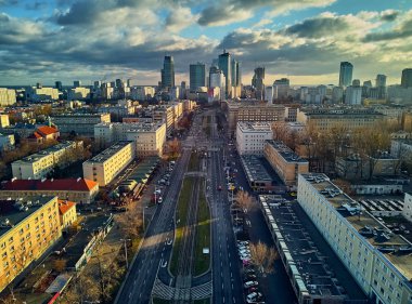 Beautiful panoramic aerial drone view to the ?enter of modern Warsaw city with silhouettes of skyscrapers in in the rays of the setting winter January sun - amazing sunset, Poland clipart