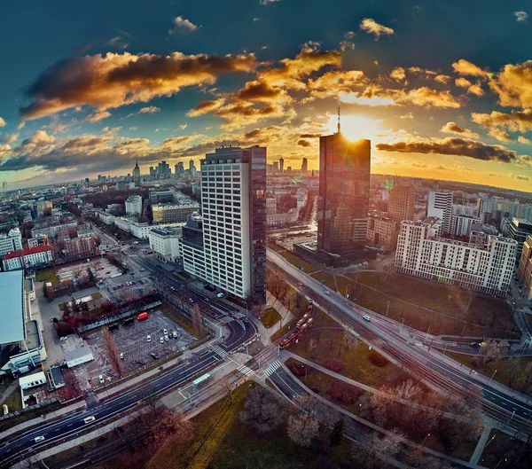 Beautiful panoramic aerial drone view to the ?enter of modern Warsaw city with silhouettes of skyscrapers in in the rays of the setting winter January sun - amazing sunset, Poland — 스톡 사진
