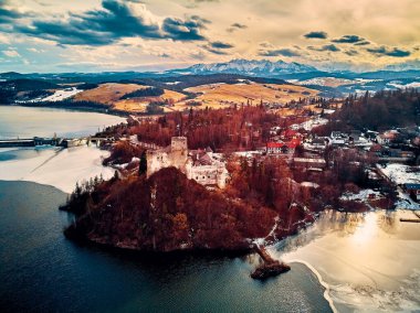 Beautiful panoramic aerial drone view to the Niedzica Castle also known as Dunajec Castle, located in the southernmost part of Poland in Niedzica, Nowy Targ County, Dunajec River, Lake Czorsztyn, PL clipart