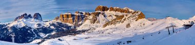 Beautiful panoramic view to the Sellaronda - the largest ski carousel in Europe - skiing the four most famous passes in the Dolomites, Italy; extraordinary snowy peaks of the dolomites, southern alps clipart