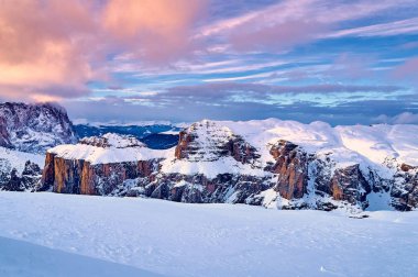 Beautiful panoramic view to the Sellaronda - the largest ski carousel in Europe - skiing the four most famous passes in the Dolomites, Italy; extraordinary snowy peaks of the dolomites, southern alps clipart