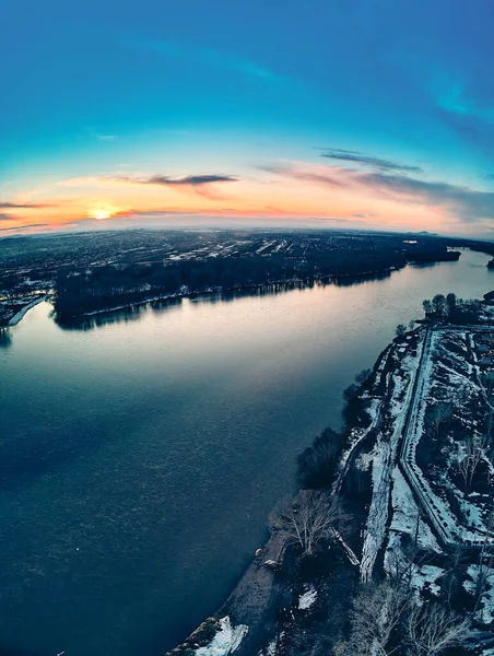 Panoramic aerial view: beautiful spring landscape: the Irtysh river in Kazakhstan wakes up from winter sleep - ice drift - snow and ice are melting at sunset, Qazaqstan