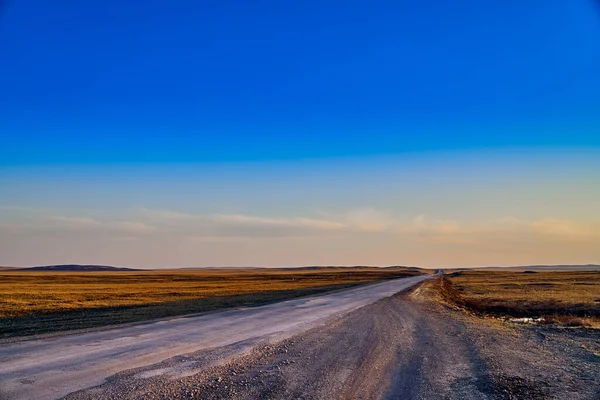 Panoramic view: beautiful spring landscape: spring huge great steppe wakes up from winter sleep - snow and ice just melted, sunset, Kazakhstan (Qazaqstan)