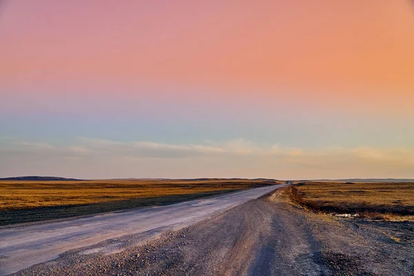 Panoramic view: beautiful spring landscape: spring huge great steppe wakes up from winter sleep - snow and ice just melted, sunset, Kazakhstan (Qazaqstan)