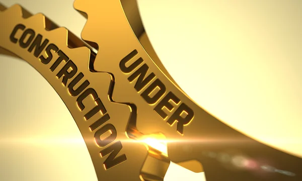 Under Construction on Golden Metallic Cog Gears. 3D. — Stock Photo, Image