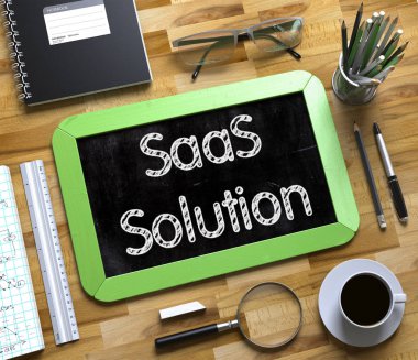 SaaS Solution Concept on Small Chalkboard. 3d. clipart