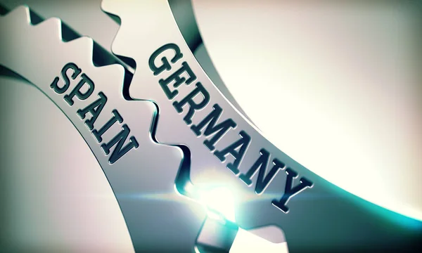 Německo Španělsko - nápis na mechanismu kovová ozubená kola. 3D. — Stock fotografie