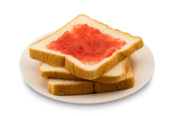 Grămadă de pâine feliată cu gem de căpșuni într-o farfurie — Fotografie, imagine de stoc