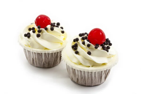 Cup cake garnished with white cream and cherry — Stock Photo, Image