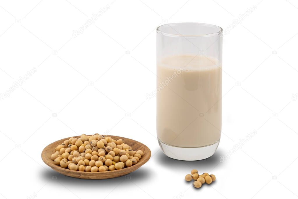 Soymilk in a glass and soy beans in a wooden plate on white background with clipping path.