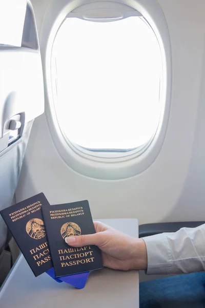 Belarusian passports in the hand on the plane
