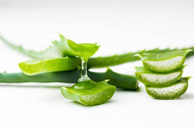 aloe vera beyaz arkaplanda akan meyve suyu ile yakın plandan ayrılıyor