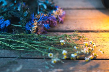 Eski ahşap koyu arka plan üzerinde kır çiçekleri.