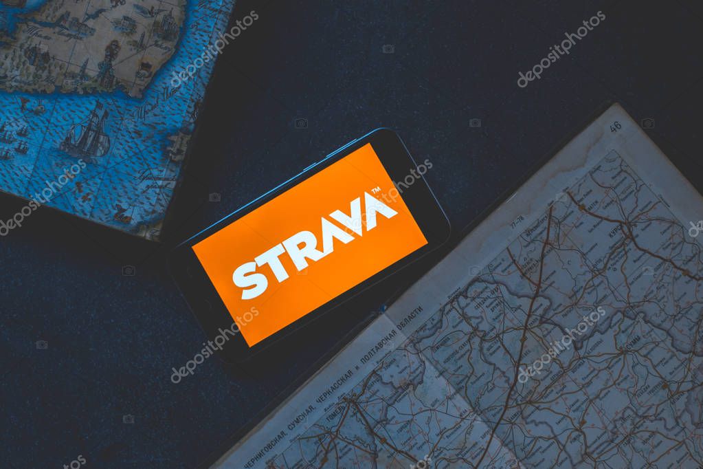 Strava application on the phone on a dark background with map