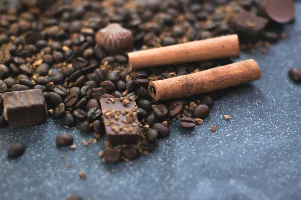 Tatlı natürmort. Kahve çekirdekleri, çikolata ve tarçın.