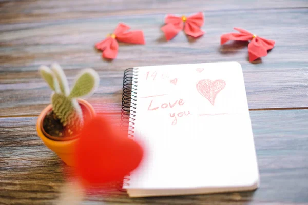 Napis kocham Cię na biały Notatnik na podłoże drewniane — Zdjęcie stockowe