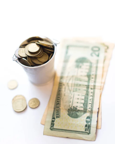 A bucket with pennies dollars on a white background. — Stock Photo, Image