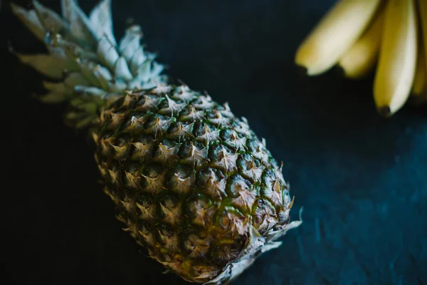 Pineapple on a black matte cement background