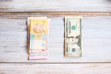 Ukraynalı hryvnia ve ahşap arka plan üzerinde Amerikan Doları