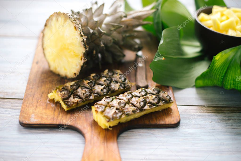 Sliced fresh pineapple on a wooden background