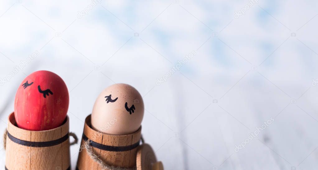 Easter eggs in a small wooden barrel on a blurred background