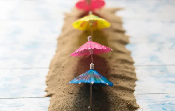 Summer concept. Beach umbrellas on a wooden blue background — Stock Photo, Image