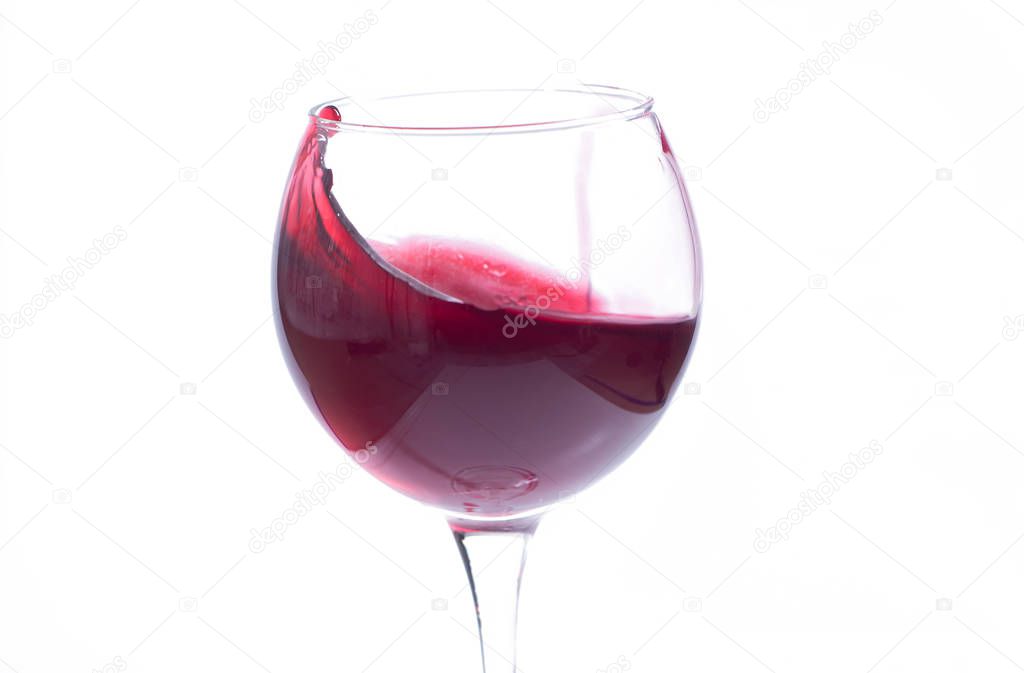 A glass with red wine on a white background. Isolate
