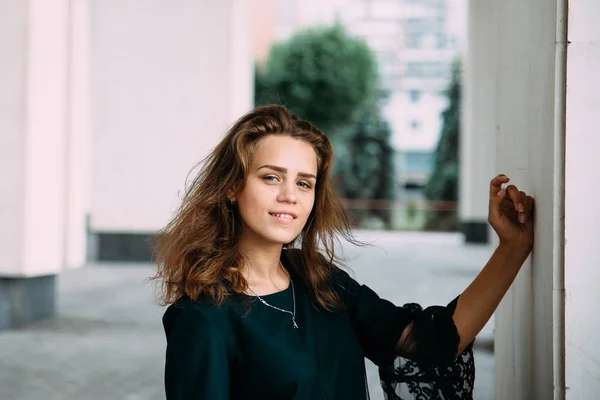 Menina jovem em vestido verde perto de edifício grande branco — Fotografia de Stock