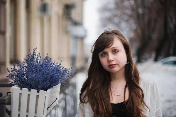 Girl in winter in a cardigan on a street in the city — Stock Photo, Image