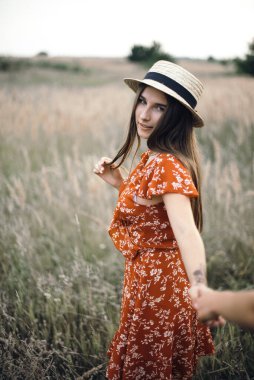 Follow me frame. Girl holds hand in summer sunny field