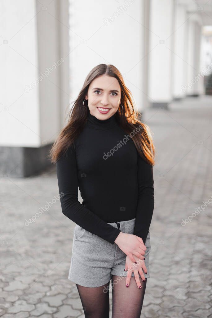 Street urban shooting. Girl on a textured background in the city