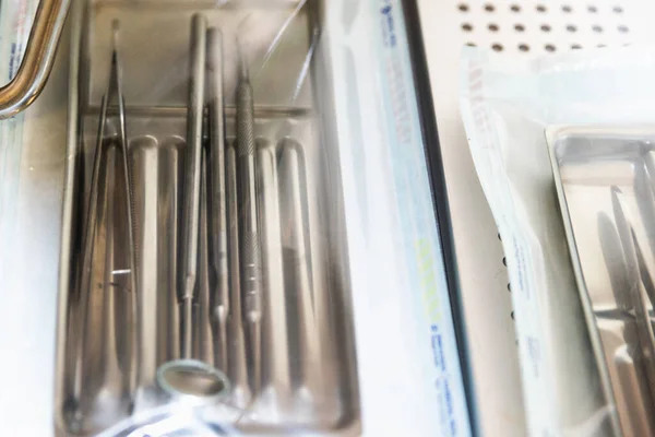Dental appliances in sterile packaging with blurry background.