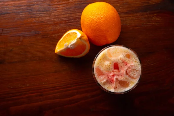 Homemade orange cocktail on a wooden dark background — Stock Photo, Image