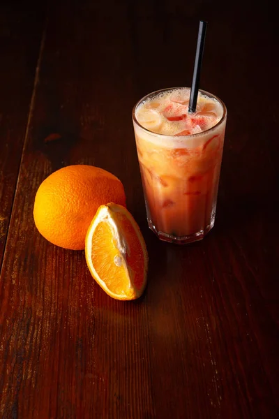 Homemade orange cocktail on a wooden dark background — Stock Photo, Image