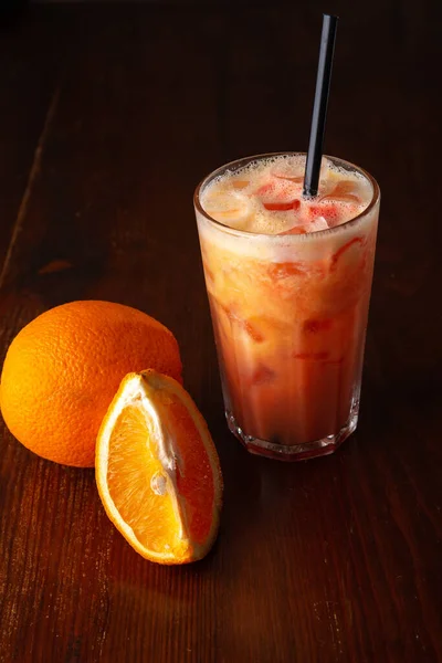 Orange cocktail on a wooden background in a bar — Stock Photo, Image