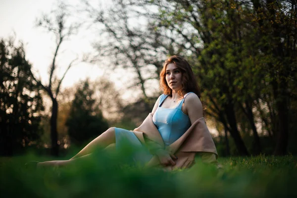 Bahar parkında mavi elbiseli güzel bir kız. — Stok fotoğraf