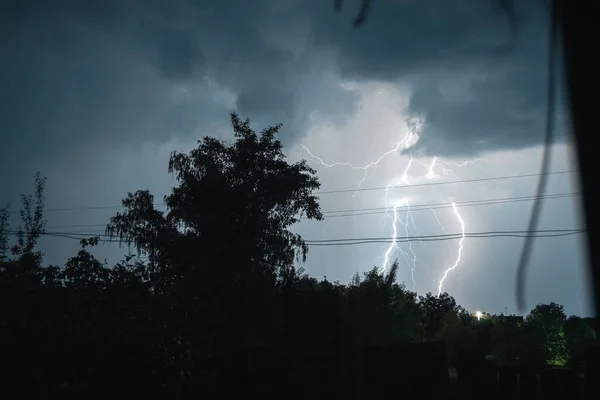 Summer night thunderstorm with powerful lightning in the village — Stock Photo, Image