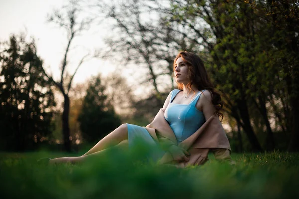 Bahar parkında mavi elbiseli güzel bir kız. — Stok fotoğraf