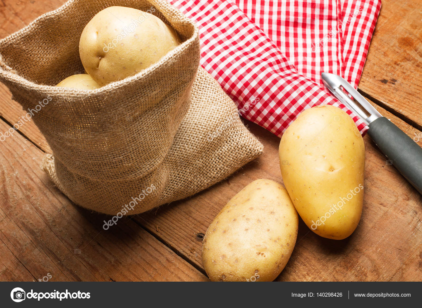 Potatoes In A Burlap Bag And Potatoe Peeler Stock Photo Potatoes In A Burlap Bag And Potatoe Peeler Stock Photo