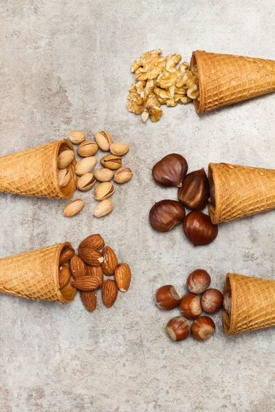Ice cream cones with nuts on a marble table