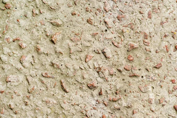 Concrete wall with granite pebbles — Stock Photo, Image