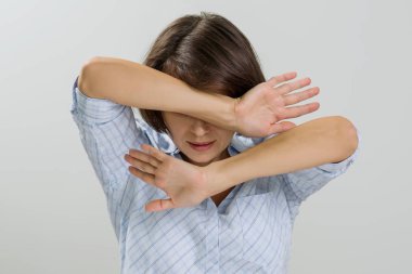 Stressed woman covering her face with hands at home.