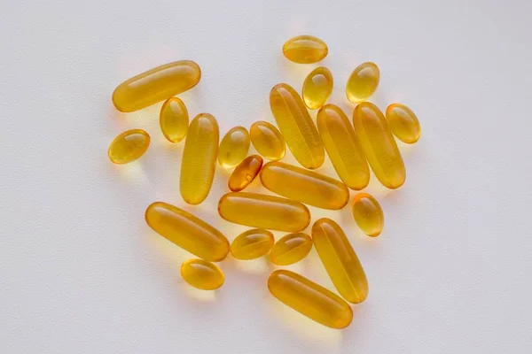 Fish oil Omega-3 capsules on a white background. — Stock Photo, Image