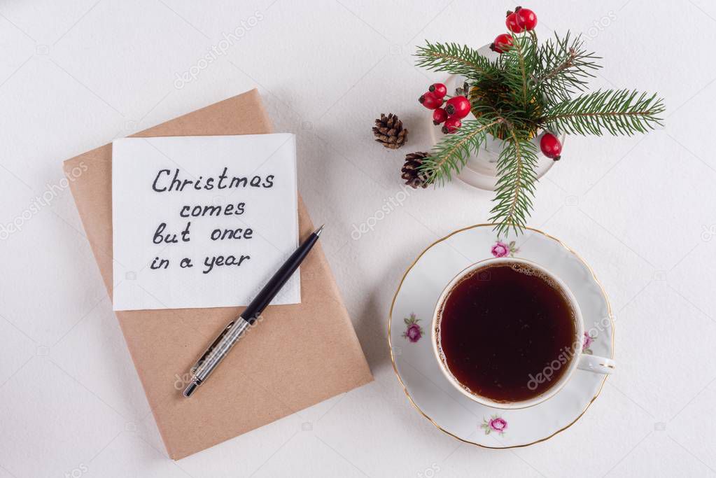 Merry Christmas greetings or wishes - Handwritten text with wishes on a napkin - Christmas comes but once in a year
